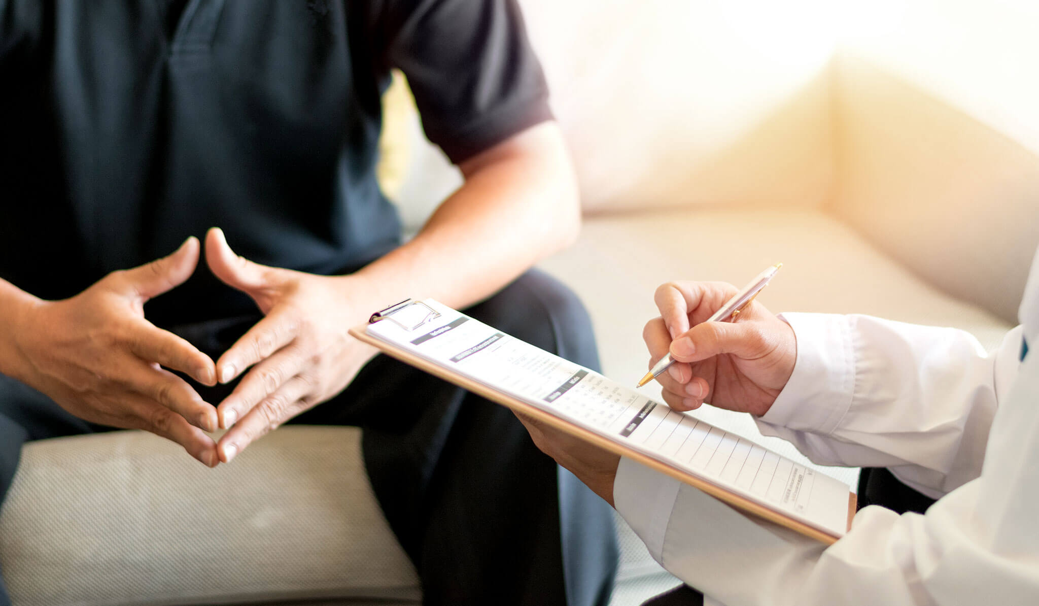 Male patient discussing his sperm health analysis with his doctor.